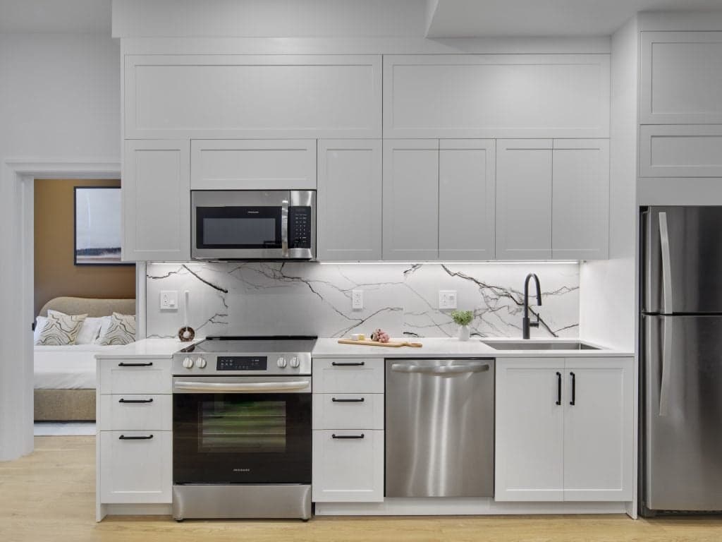 Finished unit kitchen at 1001 Residences with stone backsplash